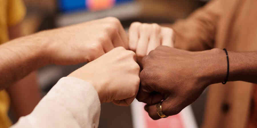 Four Different Hands Fist Bumping